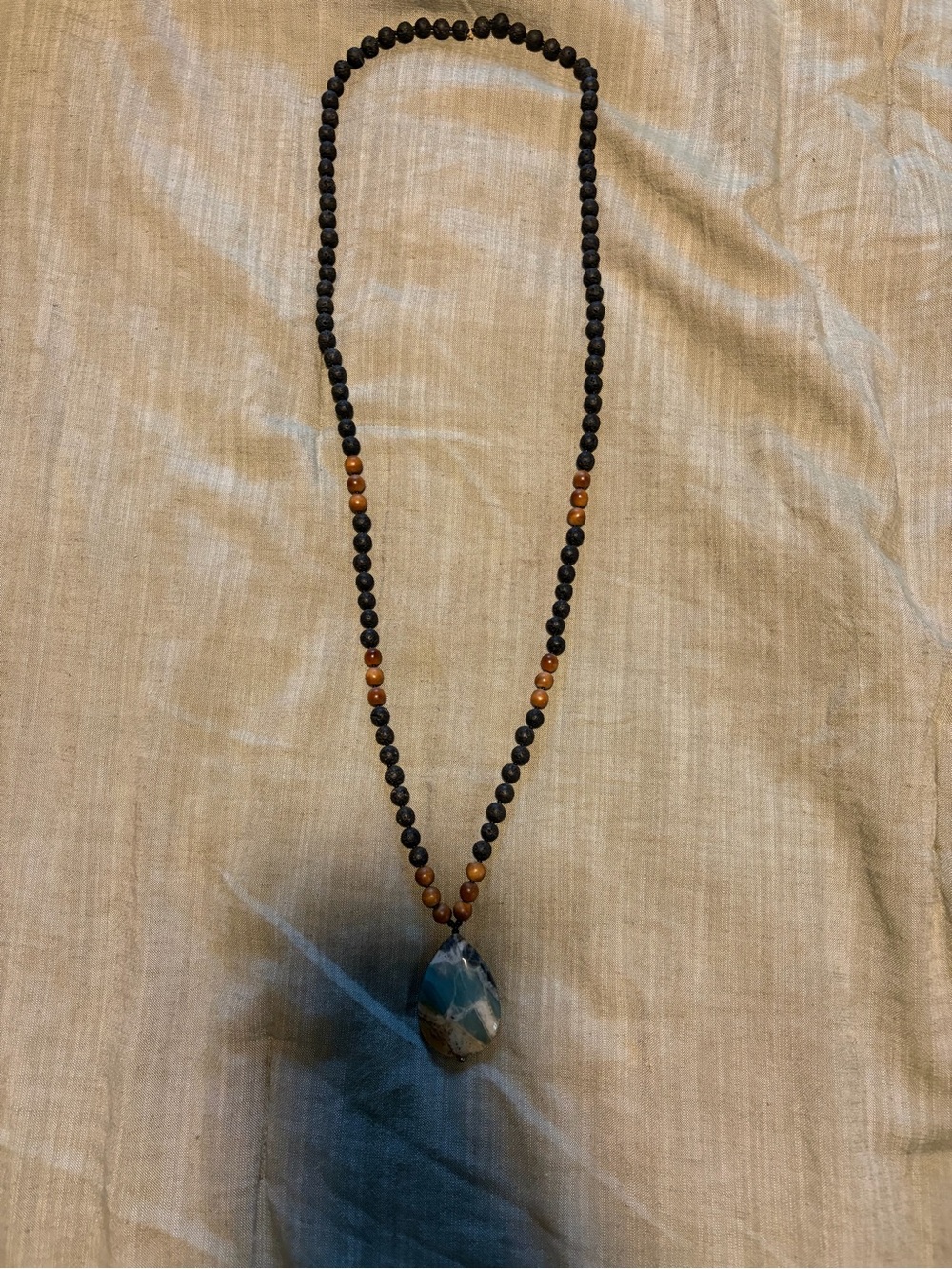 Handcrafted Black and Brown Beaded Necklace with Blue Stone Pendant
